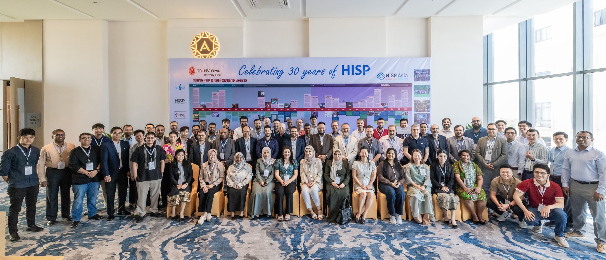 Delegates gathered in front of a Celebrating 30 Years of HISP banner at the 2024 conference